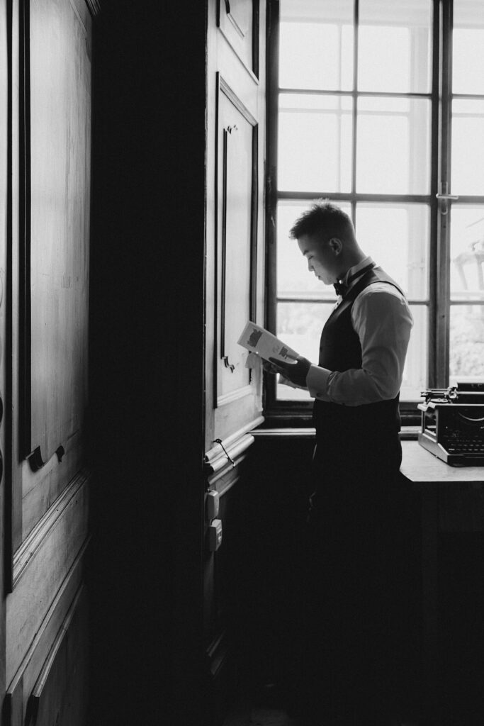 Groom getting ready in library at Schloss Leopoldskron Salzburg