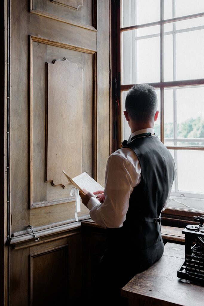 Groom getting ready in library at Schloss Leopoldskron Salzburg
